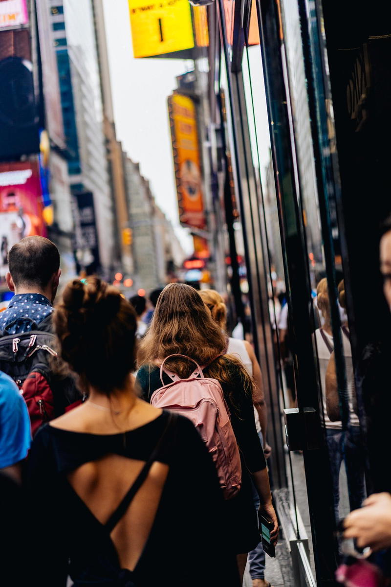 A group of people walking down a city street.