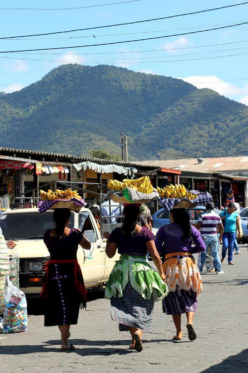 A group of women walking down a street.