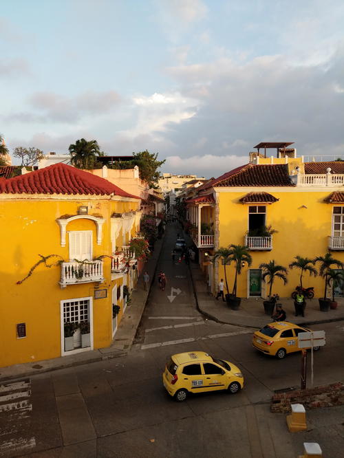 A yellow building on a street.