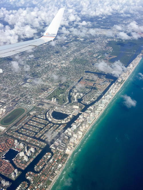 A plane flying over a city.