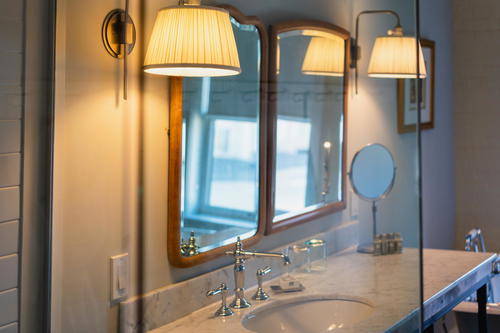 A bathroom with two sinks and a mirror.