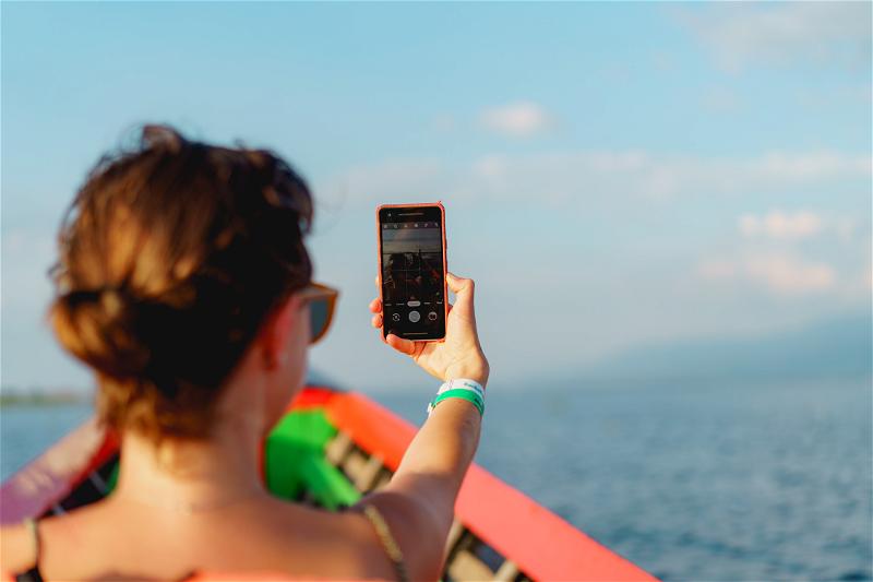 Woman taking selfie photo with Google Pixel phone at Inle Lake, Myanmar (Burma)