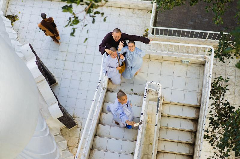 A group of people standing on a stairway.