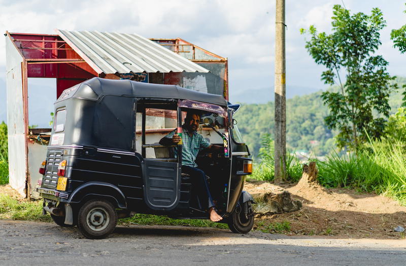 A man is driving a rickshaw.