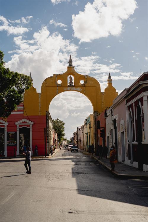 A street with a yellow archway.