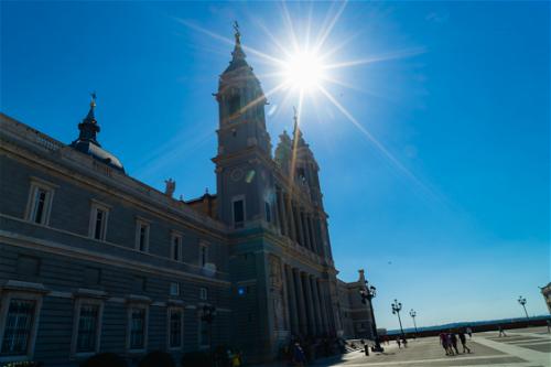 Sun glare in a deep blue sky at one of Madrid's most famous cathedrals