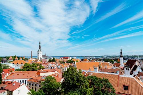 Swirled white clouds in a blue sky above Tallinn's historic town in Estonia
