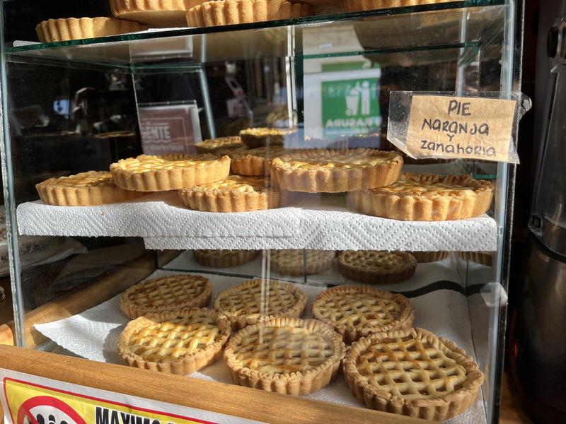 A display of pastries in a glass case.