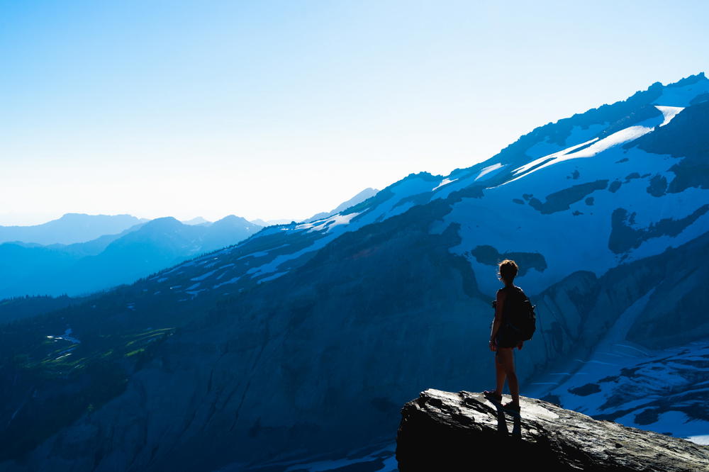 A person standing on top of a mountain.