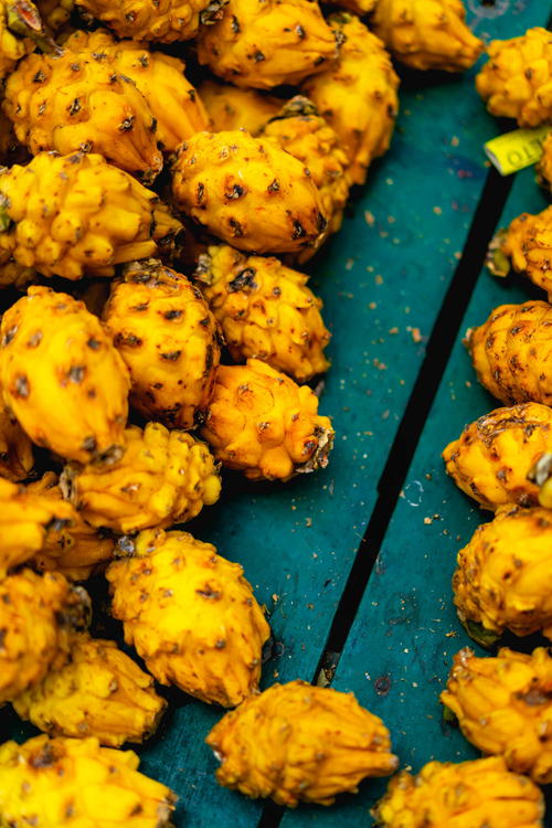 Pitahayas or yellow dragon fruits in a teal wooden box