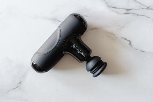 A black handheld device on a marble surface.