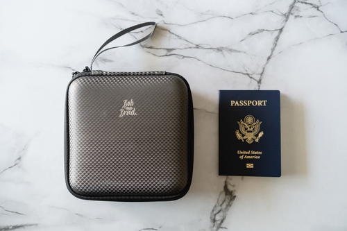 A travel case with a passport and a traveler's check.