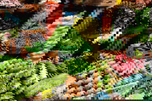 A variety of fruits and vegetables are on display at a market.