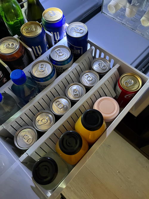 A milk bottle for a baby in a mini fridge at a hotel,