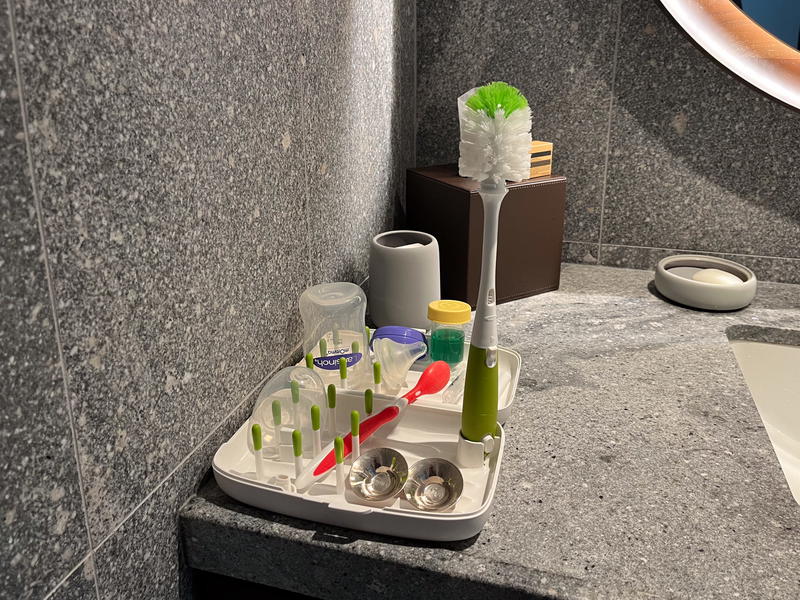 A baby bottle brush in a bathroom at a hotel.
