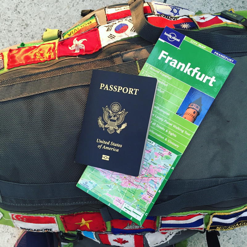 A backpack with a map and a passport on it.