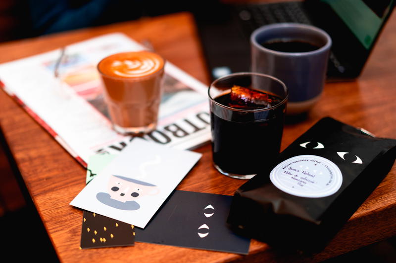 A cup of coffee and a cup of tea on a table.