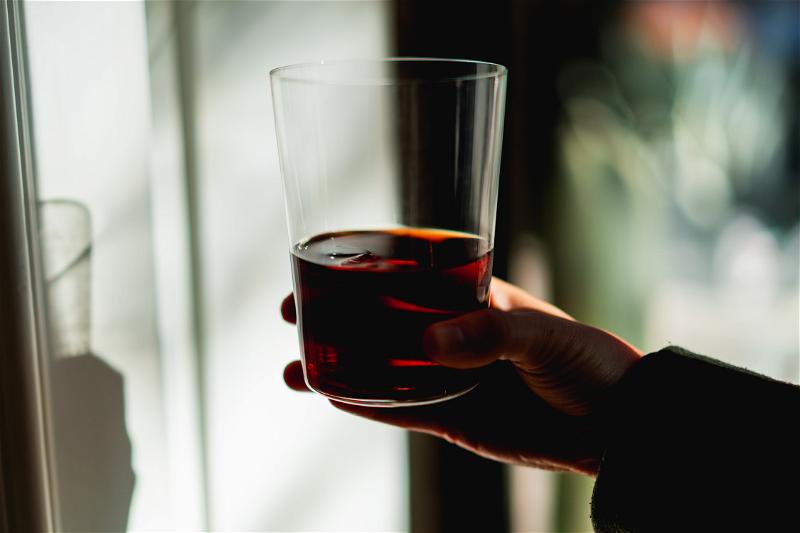 A person holding a glass of wine.