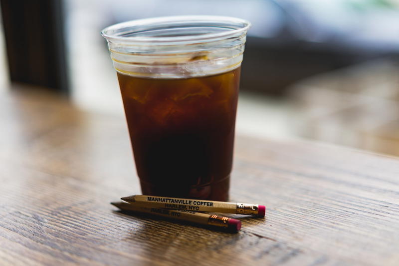 A cup of coffee on a wooden table.