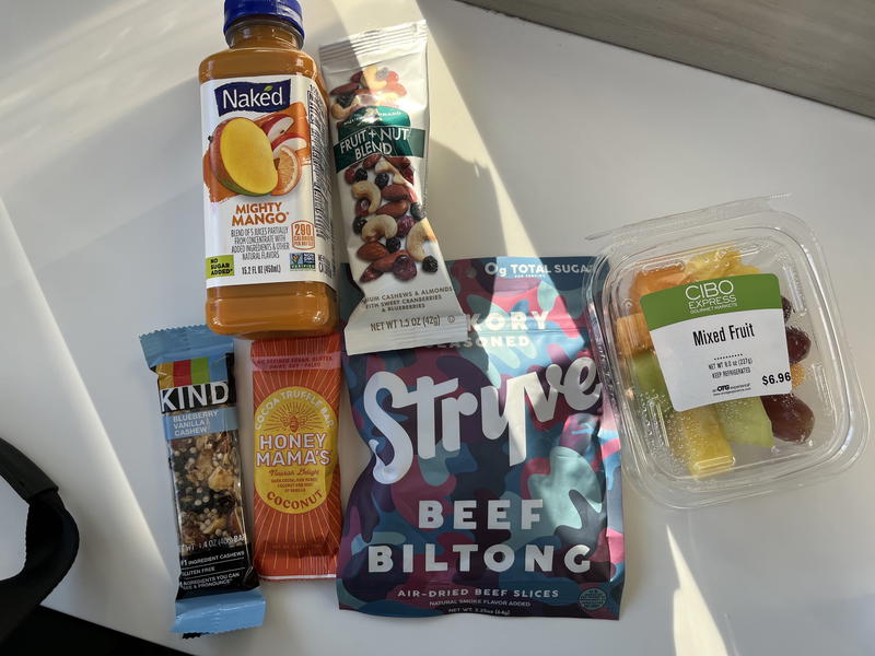 A variety of snacks and drinks are sitting on a table.