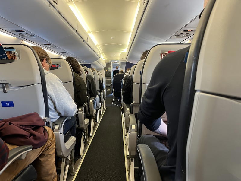 A group of people sitting on a plane.