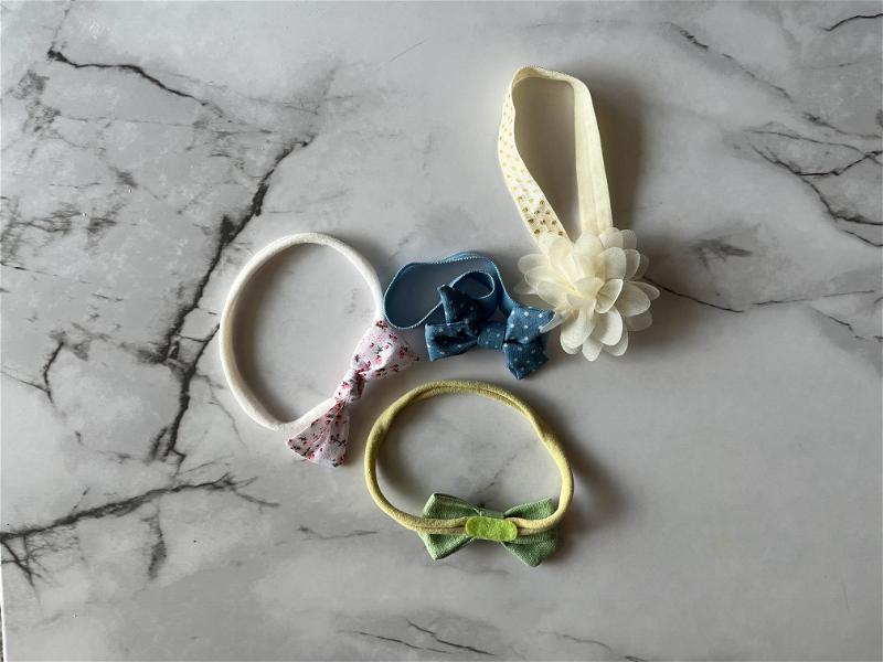 A set of baby headbands on a marble table.