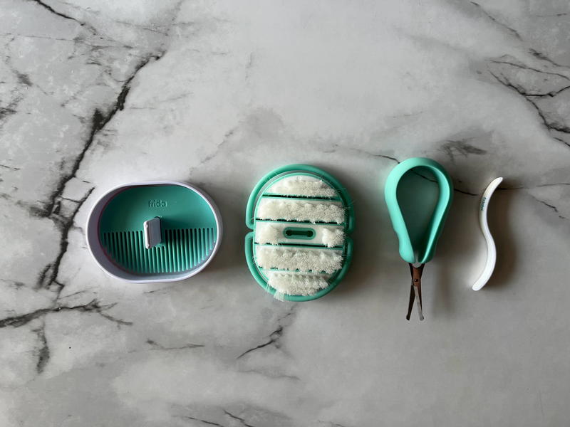 A set of toothbrushes and brushes on a marble countertop.