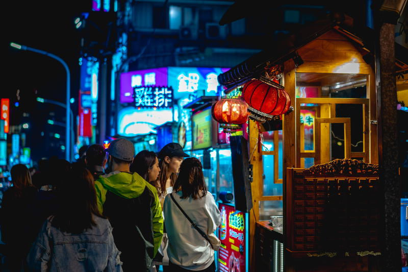 Taiwanese locals visit Raohe night market and street vendor stalls in Taipei, Taiwan