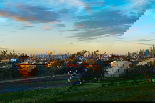 View of Freedom Tower and Manhattan Skyline seen from Sunset Park in Brooklyn at sunset