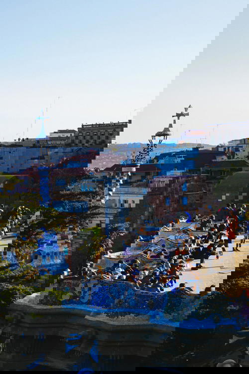 View of winding gaudi style blue and white tiled benches