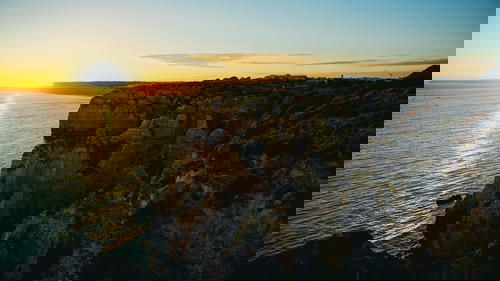Sunset at cliffs near the water in Portugal