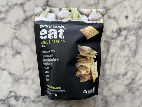 A bag of garlic chips on a marble countertop.