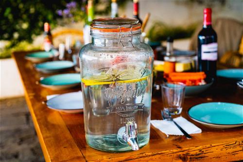 A glass jug filled with water on a table.