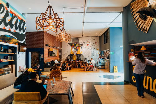 The interior of a coffee shop with a mural on the wall.