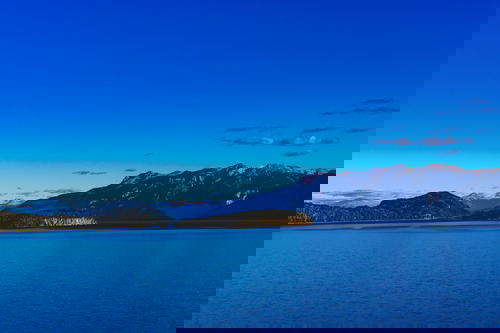 A large body of water with mountains in the background.