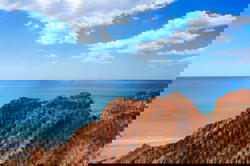 A rocky cliff overlooking the ocean.