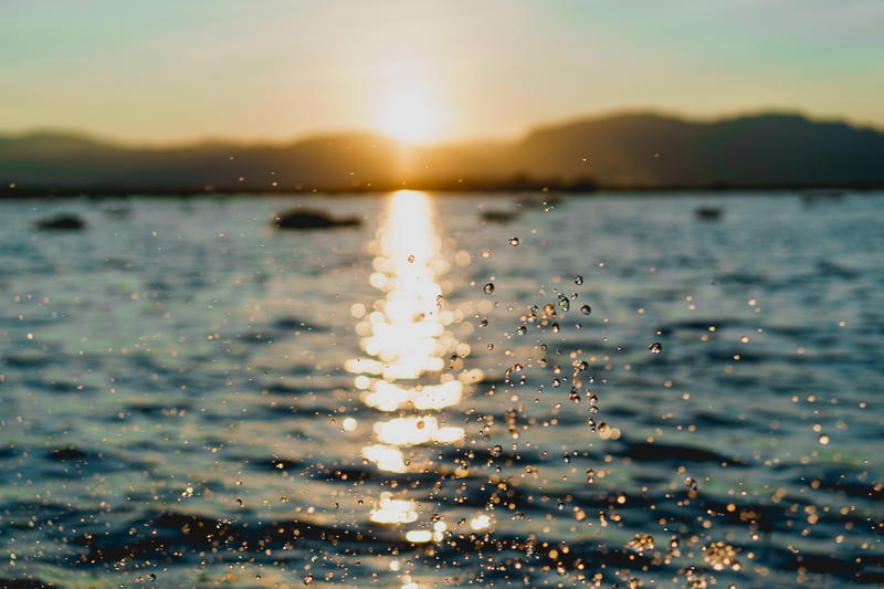 The sun is setting over a body of water.