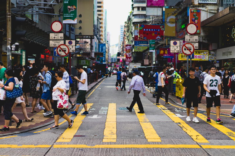 A crowd of people crossing a street.