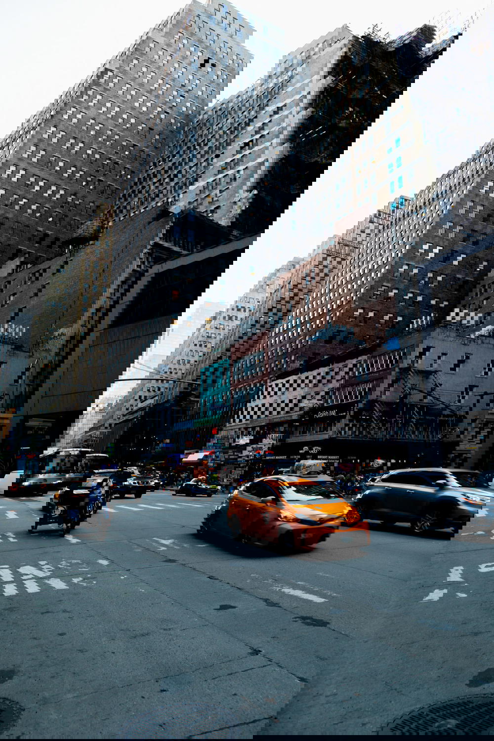 Moody street in New York City with a yellow cab driving down the street