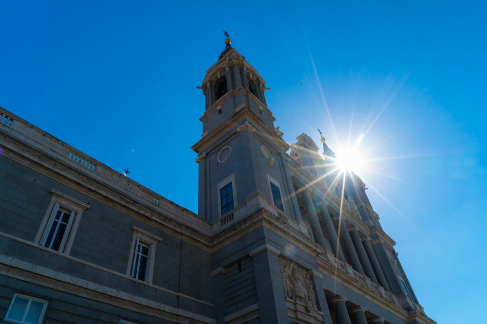 The sun is shining on the top of the building in Madrid, Spain.