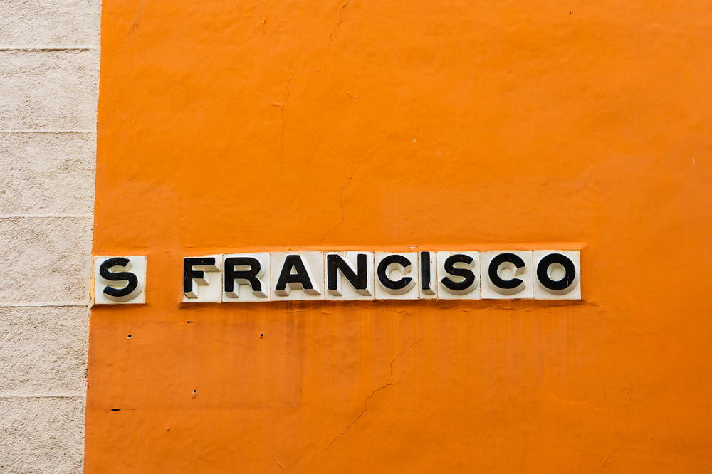 Street sign in Canary Islands style with tiles in a painted wall