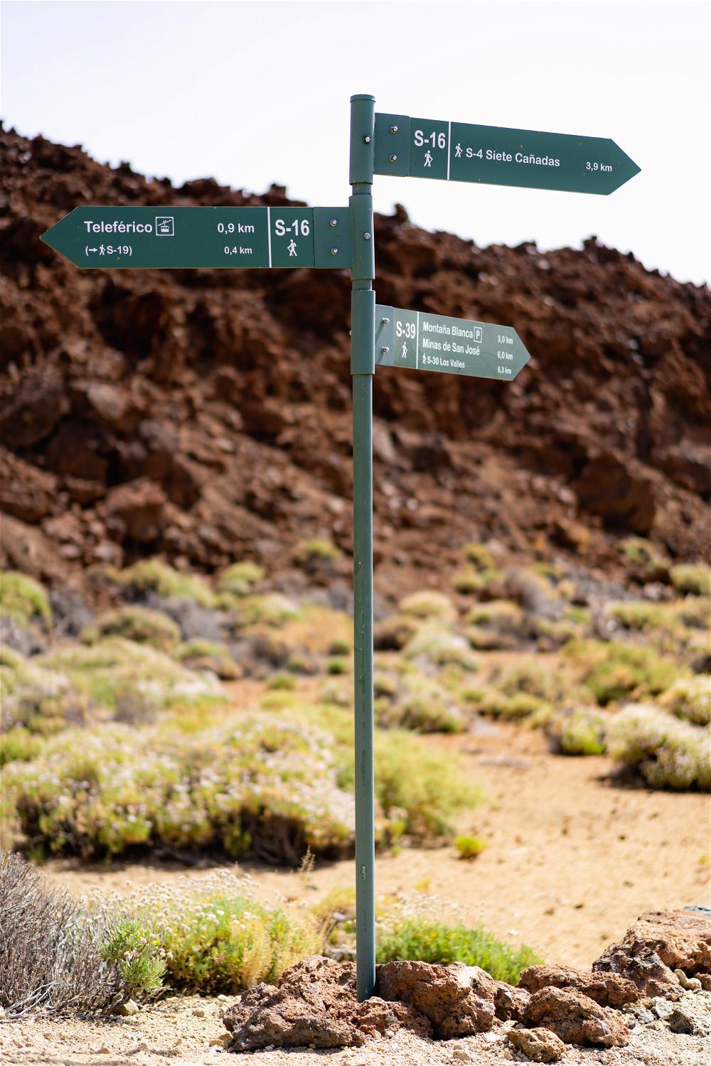 Hiking signs point travelers toward different hiking routes at El Teide