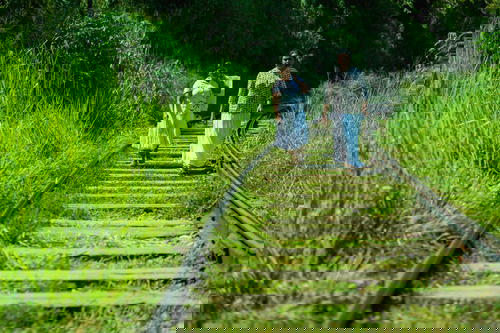 Two individuals strolling along a railway track in Sri Lanka.
