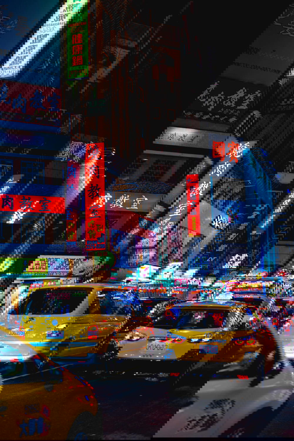 A city street in Taipei at night.