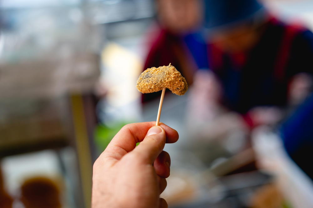 White rice flour peanut treat served on a toothpick in Taipei