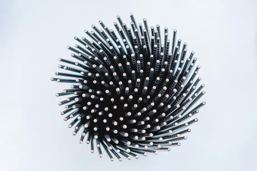 Cup of metal chopsticks arranged in a swirl pattern