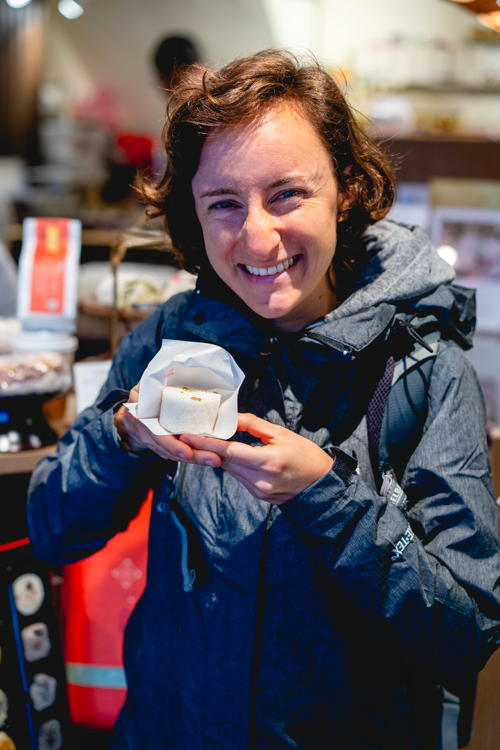 Woman holding a steamed sweet rice treat at a boutique store in Dadaocheng Taipei Taiwan