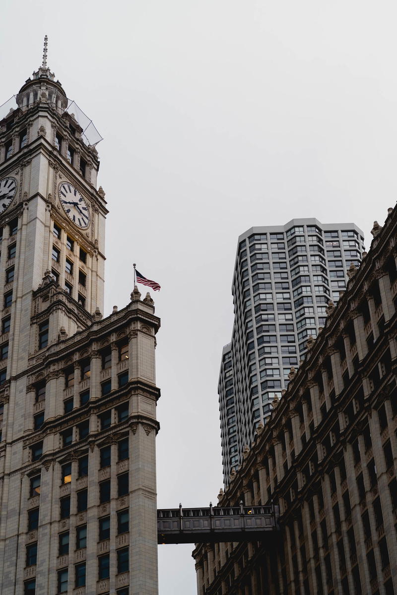 A tall building with a clock tower in the background.