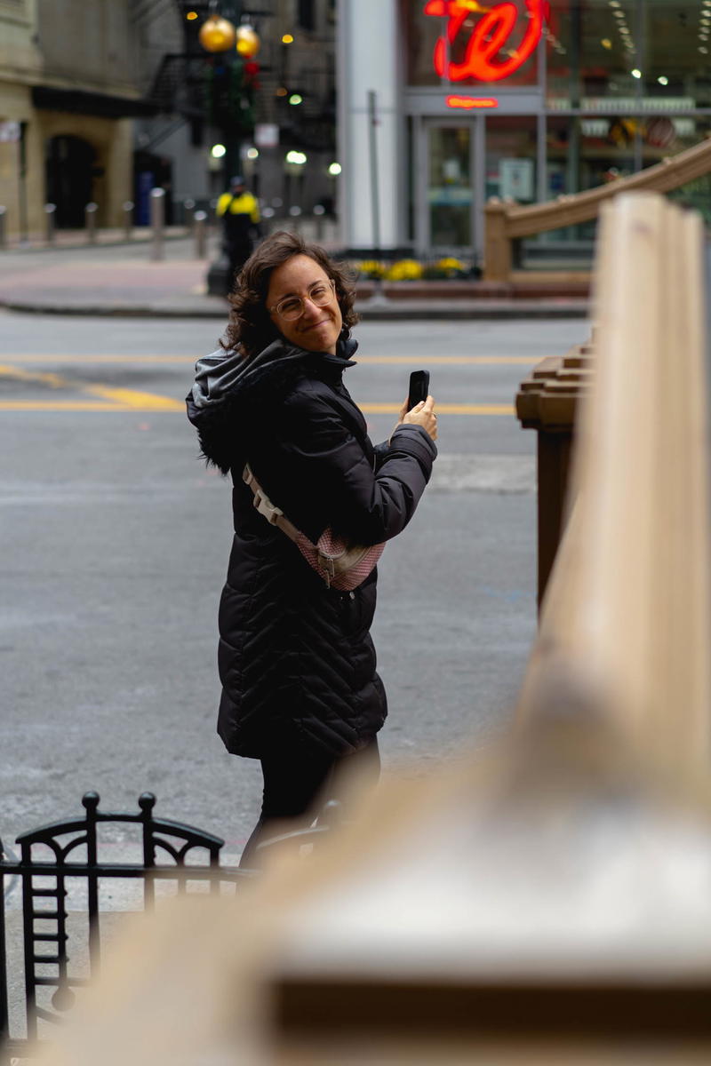 A woman holding a cell phone in Chicago.