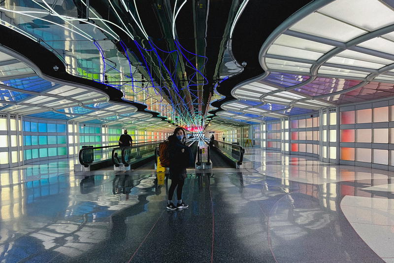 People walking through an airport.